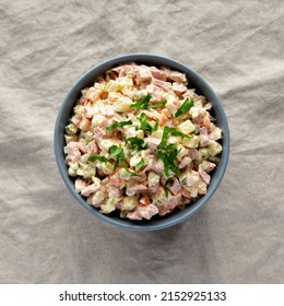 Homemade Olivier Salad In A Bowl On A White Wooden Background, Top View. Flat Lay, Overhead, From Above. 