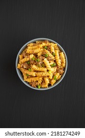 Homemade One-Pot Cheeseburger Pasta In A Bowl On A Black Background, Top View. Flat Lay, Overhead, From Above.