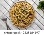 Homemade One-Pot Creamy Chicken Marsala Pasta with Parsley on a Plate, top view. 