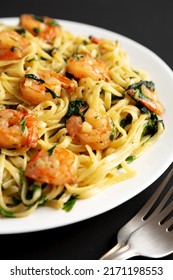 Homemade One-Pot Lemon Garlic Shrimp Pasta On A Plate On A Black Background, Side View.