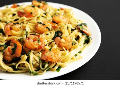 Homemade One-Pot Lemon Garlic Shrimp Pasta On A Plate On A Black Background, Side View.