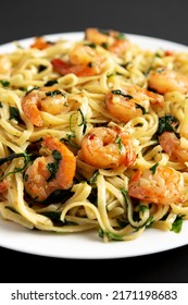 Homemade One-Pot Lemon Garlic Shrimp Pasta On A Plate On A Black Surface, Side View.