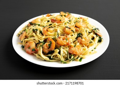 Homemade One-Pot Lemon Garlic Shrimp Pasta On A Plate On A Black Background, Side View.