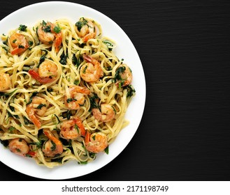 Homemade One-Pot Lemon Garlic Shrimp Pasta On A Plate On A Black Background, Top View. Copy Space.