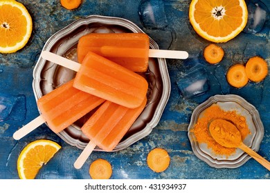 Homemade Orange And Carrot Natural Juice Popsicles With Turmeric, Honey And Ginger