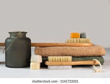 Homemade Organic Plant-based Soap And Bamboo Massage Brush With Natural Bristles On A Green And Beige Terry Towels. Eco-friendly, Biodegradable, Zero Waste.