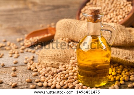 Homemade organically produced soybean oil on a rustic wooden table