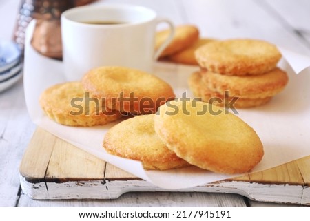 Homemade palets bretons. Salty shortbread Breton cookies, cup of coffee and cezve on light background. Focus selective