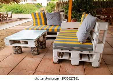 Homemade pallet furniture in the garden in summer 