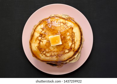 Homemade Pancakes With Butter And Maple Syrup On A Pink Plate, Overhead View. Flat Lay, Top View, From Above. Close-up.