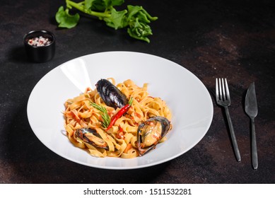 Homemade Pasta With Mussels, Sprinkle With Chopped Parsley And Basil. Delicious Of Pasta With Mussel