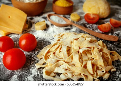 Homemade Pasta Tagliatelle With Eggs Tomatoes And Chees. Fresh Pasta Making On Board, Food Photo