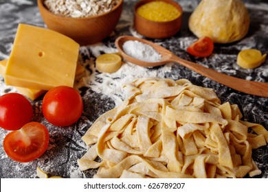 Homemade Pasta Tagliatelle With Eggs Tomatoes And Chees. Fresh Pasta Making On Board, Food Photo