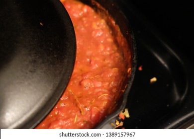 Homemade Pasta Tomato Sauce Simmering Under A Cast Iron Lid