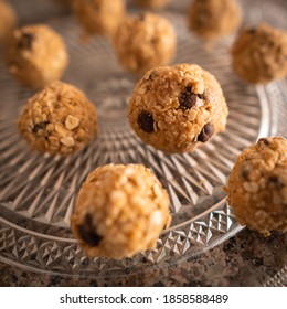 Homemade Peanut Butter Balls With Oats, Chocolate Chips And Honey, On A Glass Plate