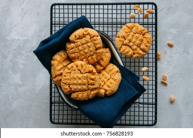 Homemade peanut butter cookies on a wire rack. Gray background. Rustic style.