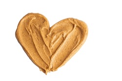 Homemade Peanut Butter And Patterned Sandwich Isolated On White Background. The Concept Of Love For Nuts. Favorite Breakfast. Nuts In The Shape Of A Heart