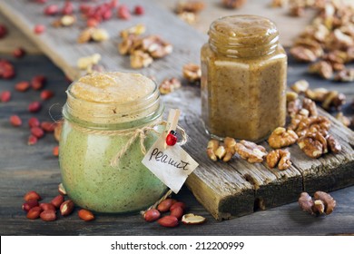 Homemade Peanut And Walnut Butter On A Wooden Table.