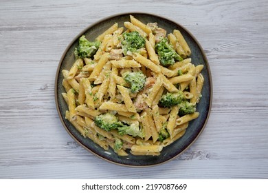 Homemade Penne Alfredo Pasta With Chicken And Broccoli On A Plate, Top View. Flat Lay, Overhead, From Above. 