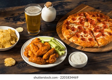 Homemade Pepperoni Pizza Chicken Wings And Beer For A Football Party