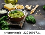 Homemade pesto sauce and ingredients, Traditional Italian pesto recipe for pasta on a dark background, top view. place for text.