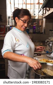 Homemade Photos Of A Latin Mother Cooking In The Kitchen