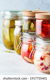 Homemade pickled or fermented vegetables - sauerkraut, wild garlic, chili, pickles, pickled tomatoes and olives in glass jars.