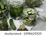 Homemade pickles. Fresh cucumbers in jars and other ingredients on table, closeup