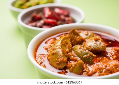 Homemade Pickles of Red/Green Chilli and Mango, also known as Mirchi and Aam ka achar Served in bowls, selective focus