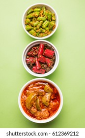 Homemade Pickles of Red/Green Chilli and Mango, also known as Mirchi and Aam ka achar Served in bowls, selective focus
