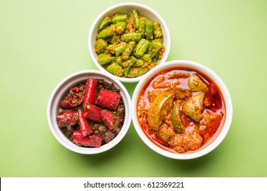 Homemade Pickles of Red/Green Chilli and Mango, also known as Mirchi and Aam ka achar Served in bowls, selective focus