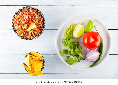 Homemade Pico De Gallo Salsa And Ingredients. Bowl Of Spicy Pico De Gallo Salsa On White Boards. Top View