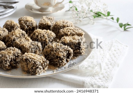 Homemade pieces of delicious chocolate and nuts cake on white background. Romanian dessert Tavalita. Overhead view.