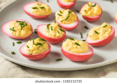 Homemade Pink Pickled Deviled Eggs With Chives