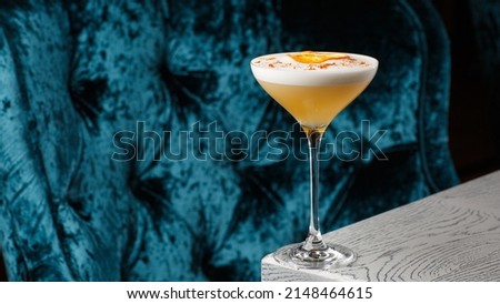 Homemade Pisco sour cocktail. Whiskey Sour in Coupe Glass with ice on gray background. Overhead view, copy space. Advertising for cafe. Bar menu