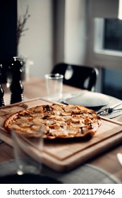Homemade pizza on wooden cuttingboard