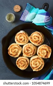 Homemade Pizza Rolls Or Pinwheels Filled With Ham, Onion, Tomato Sauce And Cheese, Photographed Overhead On Slate With Natural Light (Selective Focus, Focus On The Top Of The Rolls)