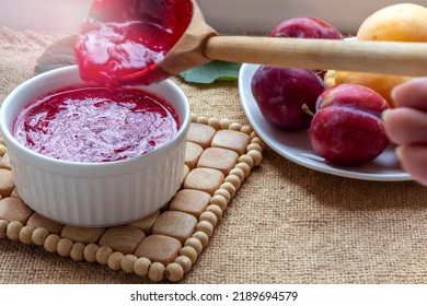 Homemade Plum Jam Preparation. Boiling , Crimson, Transparent Jam. Selective Focus .