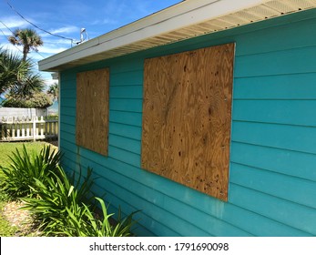 Homemade Plywood Shutters Cover A Beach Cottage’s Windows In Preparation For An Oncoming Hurricane In Florida.￼