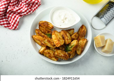Homemade potato wedges with sour cream - Shutterstock ID 1824911654