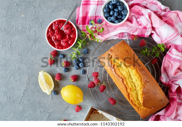 Homemade pound cake or lemon cake with berries filling
also known as gateaux de voyage cake, french cuisine, view from
above, copy space 
