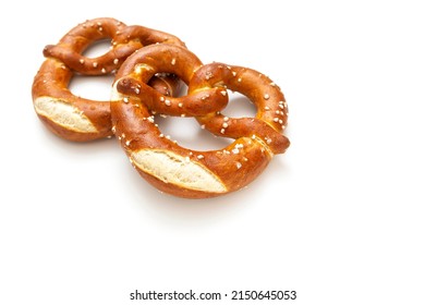 Homemade pretzels as a tasty salty snack isolated on white background