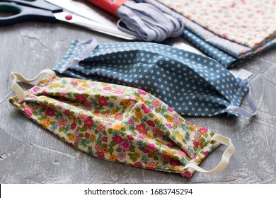 Homemade protective mask and pieces of cloth on a gray background. - Shutterstock ID 1683745294