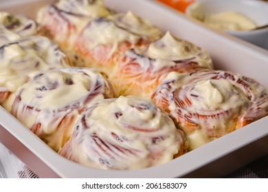 Homemade Pumpkin cinnamon rolls with cream cheese in a baking dish, flat lay, top veiw. Seasonal autumn homemade pastry - cinnabons for breakfast or holidays. - Powered by Shutterstock