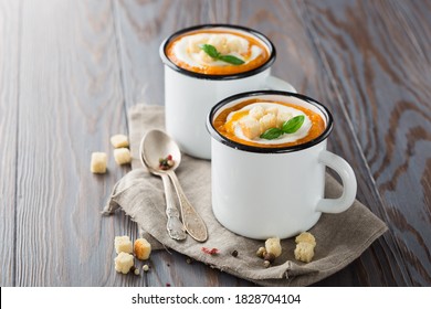 Homemade Pumpkin Vegetable Cream Soup With Cream, Croutons And Basil On Rustic Wooden Background. Concept Of Healthy Eating Oand Vegetarian Food. Copy Space.