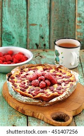 Homemade Quark Pie With Raspberries In Foil Served On Wooden Board With Green Tea