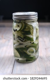 Homemade Quick Pickles Cucumbers And Onions Stored In Mason Jar On A Wooden Table. Delicious Vegetarian Appetizer.