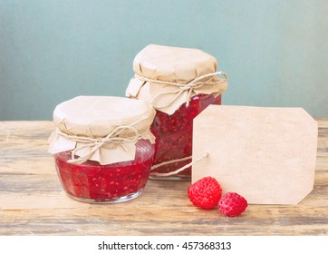 Homemade Raspberry Jam In Glass Jar, Raspberries And Paper Label On Wooden Table, Rustic Retro Style