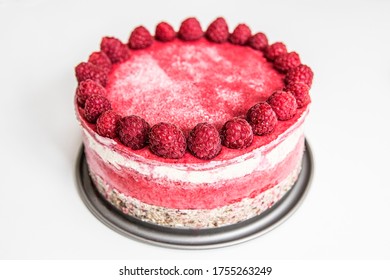 Homemade raspberry raw cake on a tin tray