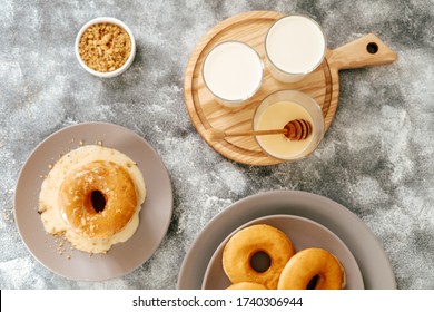 Homemade Recipe Fresh Warm Donut On Plate Flat Lay. Top Down View Of Traditional Syrup Glazed Doughnut And Glass Of Milk. Delicious Sweet Breakfast. Freshly Fried Ring Sugar Pastry